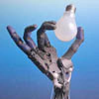 A robot hand holding a lightbulb